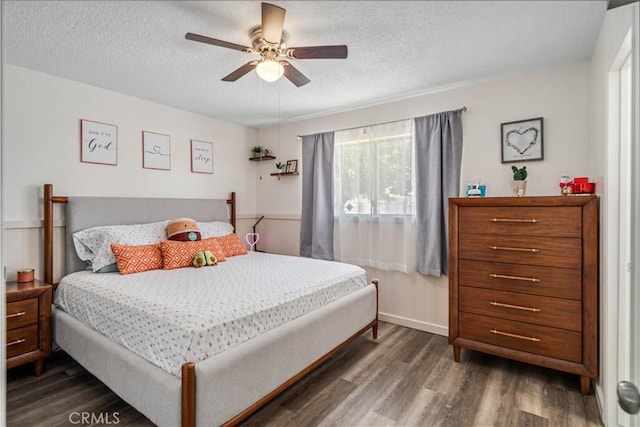 24438 Sage Ave, Boron, CA 93516 - bedroom featuring wood finished floors, a textured ceiling, a ceiling fan, and a wainscoted wall