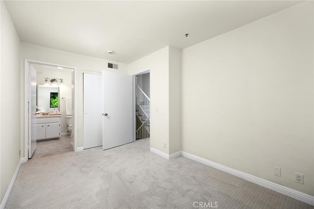 222 S Catalina Ave Unit 8, Pasadena, CA 91106 - unfurnished bedroom with light colored carpet, baseboards, and ensuite bathroom