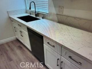 850 N Kathleen Ln, Orange, CA 92867 - kitchen featuring black dishwasher, a sink, wood finished floors, baseboards, and light stone countertops