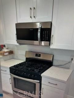 850 N Kathleen Ln, Orange, CA 92867 - kitchen with appliances with stainless steel finishes and white cabinets