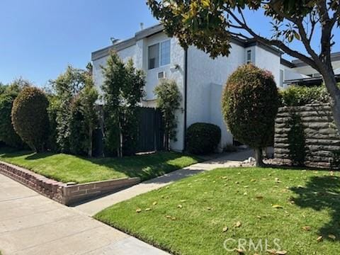 850 N Kathleen Ln, Orange, CA 92867 - view of side of home with stucco siding and a lawn
