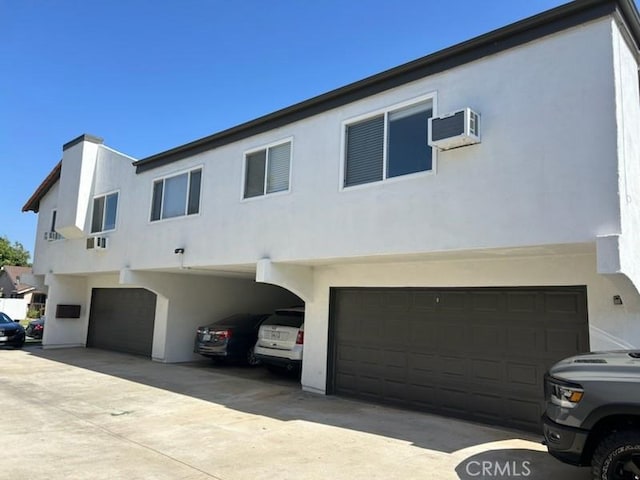 850 N Kathleen Ln, Orange, CA 92867 - view of front of house featuring an attached garage, stucco siding, and an AC wall unit