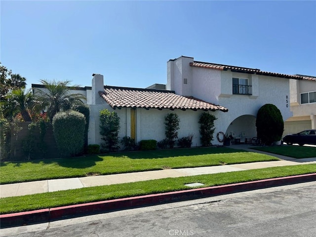 850 N Kathleen Ln, Orange, CA 92867 - mediterranean / spanish house with stucco siding, a tile roof, and a front lawn