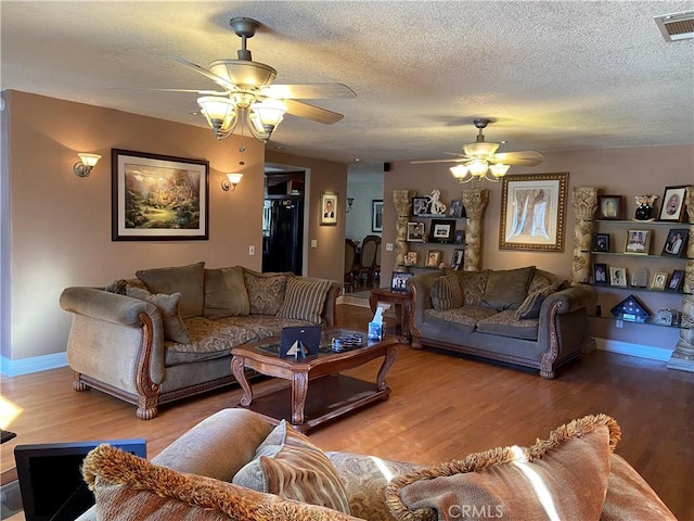 7614 Calpella Ave, Hesperia, CA 92345 - living area featuring a ceiling fan, wood finished floors, a textured ceiling, and baseboards