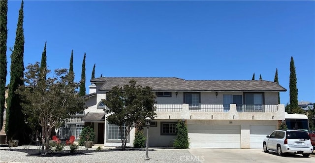 7614 Calpella Ave, Hesperia, CA 92345 - view of front of property with stucco siding, an attached garage, and driveway