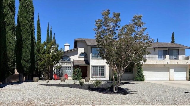 7614 Calpella Ave, Hesperia, CA 92345 - view of front of house with stucco siding, concrete driveway, an attached garage, and a chimney