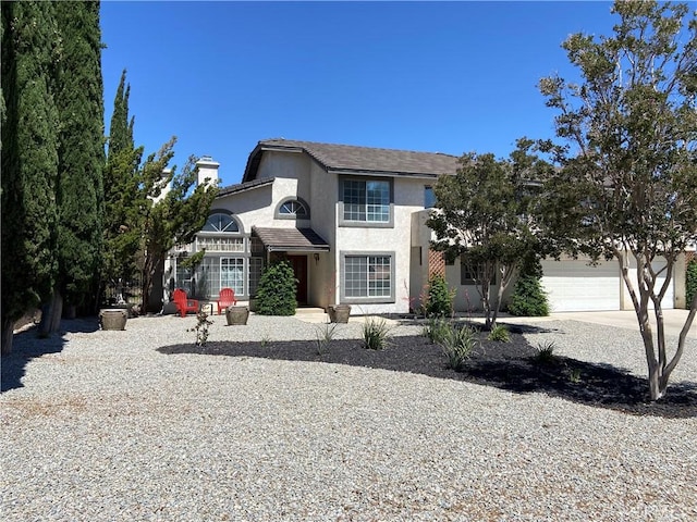 7614 Calpella Ave, Hesperia, CA 92345 - view of front facade featuring stucco siding, concrete driveway, a chimney, and an attached garage