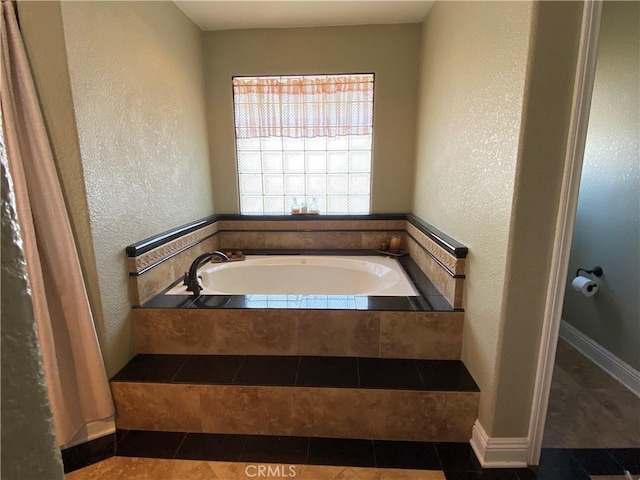 7614 Calpella Ave, Hesperia, CA 92345 - full bath featuring a textured wall, a garden tub, and tile patterned flooring