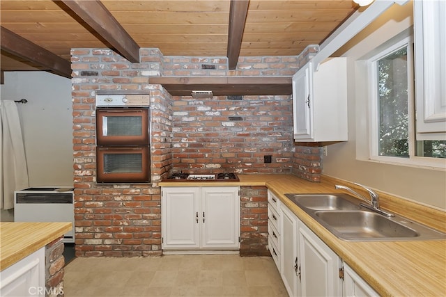197 Weisshorn Dr, Crestline, CA 92325 - kitchen featuring wooden ceiling with exposed beams, a sink, double wall oven, white cabinets, and light countertops
