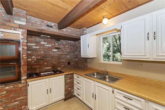 197 Weisshorn Dr, Crestline, CA 92325 - kitchen with gas cooktop, double oven, wood ceiling with exposed beams, a sink, and white cabinetry