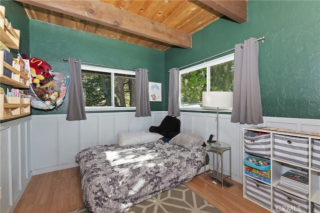 197 Weisshorn Dr, Crestline, CA 92325 - bedroom with a wood ceiling with exposed beams, wood finished floors, wainscoting, and a decorative wall