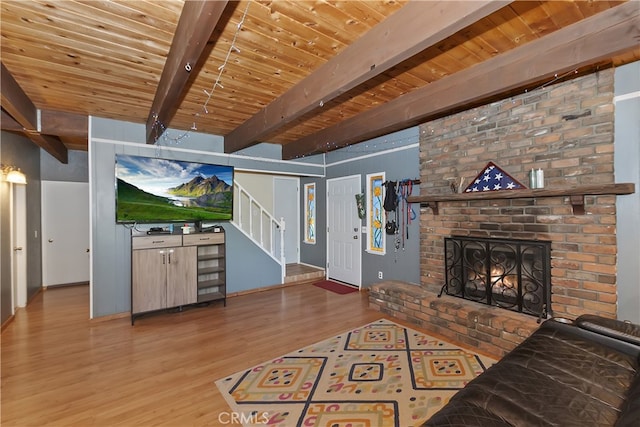 197 Weisshorn Dr, Crestline, CA 92325 - living area featuring wood finished floors, stairs, a wood ceiling with exposed beams, and a fireplace