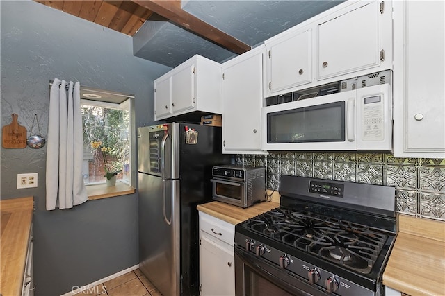 197 Weisshorn Dr, Crestline, CA 92325 - kitchen with gas stove, white microwave, freestanding refrigerator, and white cabinets