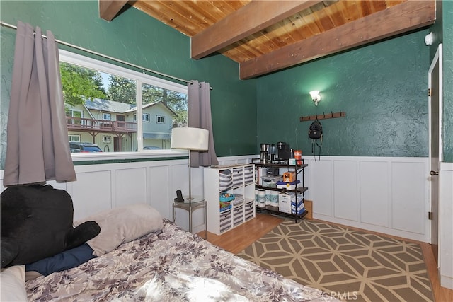 197 Weisshorn Dr, Crestline, CA 92325 - bedroom featuring wood ceiling with exposed beams, a decorative wall, wainscoting, and wood finished floors