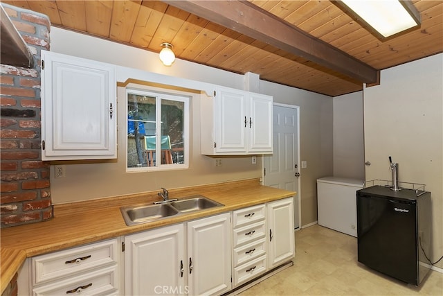 197 Weisshorn Dr, Crestline, CA 92325 - kitchen with a sink, wooden ceiling with exposed beams, light floors, light countertops, and white cabinets