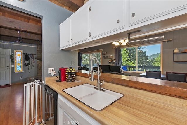 197 Weisshorn Dr, Crestline, CA 92325 - kitchen with a sink, dishwasher, white cabinetry, light countertops, and plenty of natural light