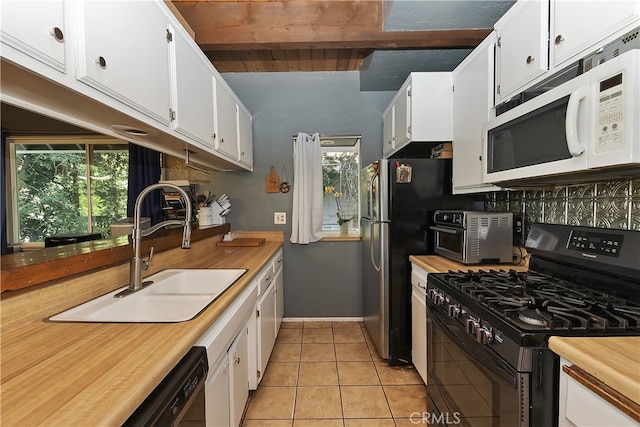 197 Weisshorn Dr, Crestline, CA 92325 - kitchen featuring black appliances, a sink, light tile patterned floors, white cabinetry, and beam ceiling