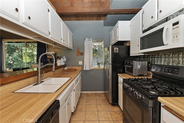 197 Weisshorn Dr, Crestline, CA 92325 - kitchen with black appliances, light tile patterned floors, white cabinetry, wood counters, and beam ceiling