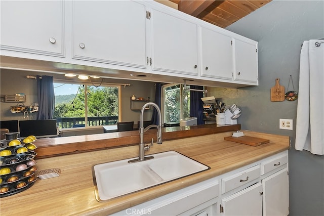 197 Weisshorn Dr, Crestline, CA 92325 - kitchen featuring a sink, white cabinets, and light countertops