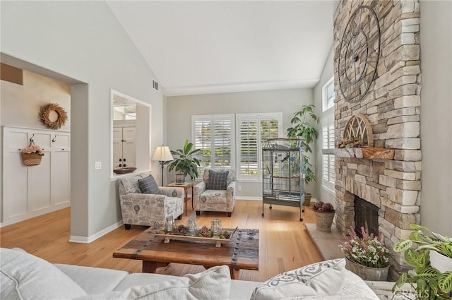 3184 Holloway Ct, Newbury Park, CA 91320 - living area with a fireplace, plenty of natural light, wood finished floors, and high vaulted ceiling