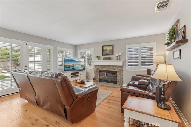 3184 Holloway Ct, Newbury Park, CA 91320 - living room with a stone fireplace, light wood finished floors, baseboards, and french doors