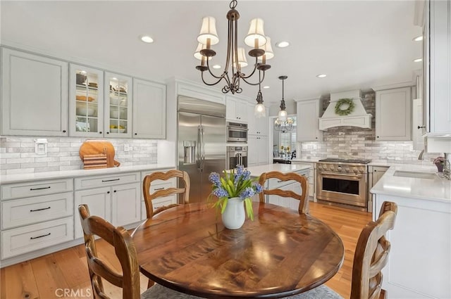 3184 Holloway Ct, Newbury Park, CA 91320 - dining room with a chandelier, light wood-style flooring, and recessed lighting