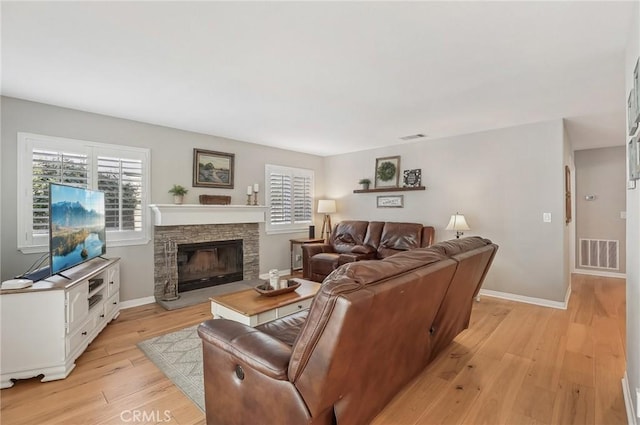 3184 Holloway Ct, Newbury Park, CA 91320 - living room featuring light wood finished floors, healthy amount of natural light, baseboards, and a fireplace