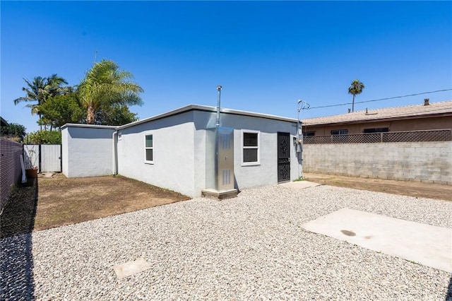 208 W Caldwell St, Compton, CA 90220 - rear view of house featuring stucco siding, a fenced backyard, and a patio