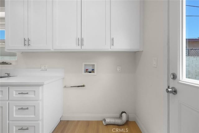 208 W Caldwell St, Compton, CA 90220 - washroom with cabinet space, baseboards, hookup for a washing machine, and light wood-style flooring