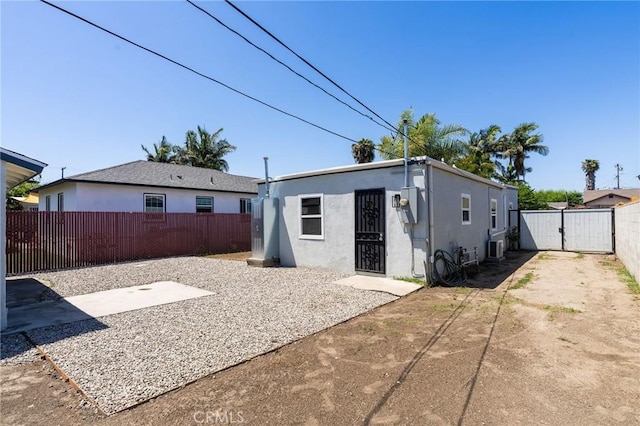 208 W Caldwell St, Compton, CA 90220 - rear view of house featuring a fenced backyard, a patio, a gate, and stucco siding