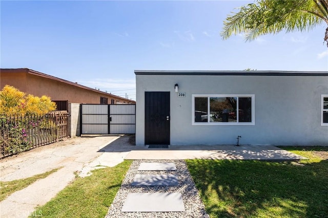 208 W Caldwell St, Compton, CA 90220 - view of front of property with stucco siding and a gate