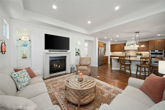 1494 Vista Tesoro Pl, Nipomo, CA 93444 - living area with dark wood-style floors, recessed lighting, a glass covered fireplace, and a raised ceiling