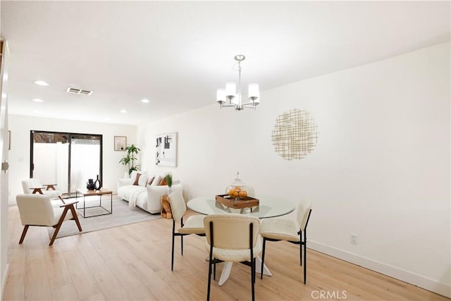 14803 Vanowen St Unit 9, Van Nuys, CA 91405 - dining room with light wood-style flooring, a chandelier, recessed lighting, and baseboards