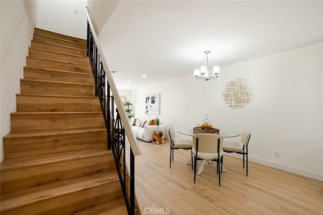 14803 Vanowen St Unit 9, Van Nuys, CA 91405 - dining area featuring stairway, light wood-style flooring, a chandelier, recessed lighting, and baseboards