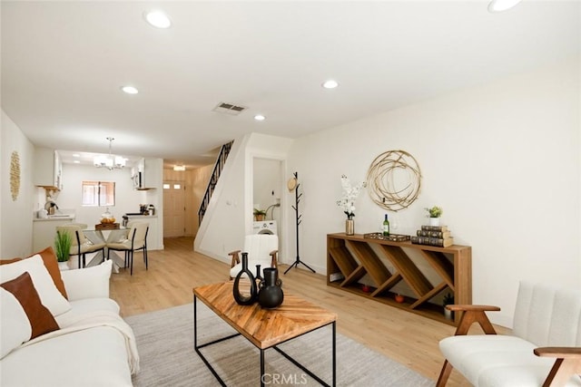14803 Vanowen St Unit 9, Van Nuys, CA 91405 - living room with light wood-style floors, stairs, recessed lighting, and a chandelier