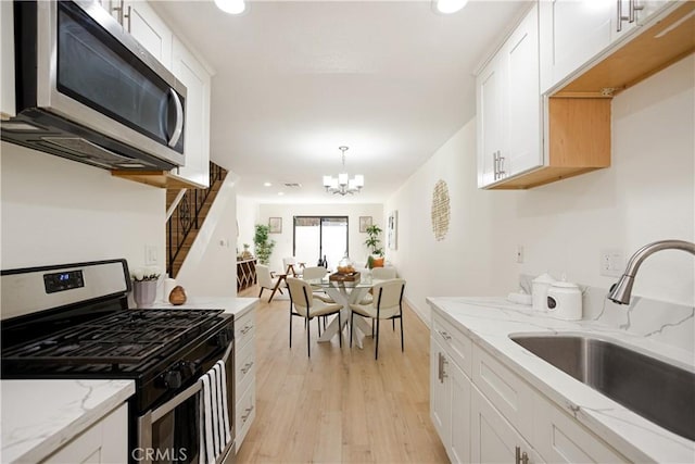14803 Vanowen St Unit 9, Van Nuys, CA 91405 - kitchen featuring appliances with stainless steel finishes, a sink, white cabinetry, light wood-style flooring, and recessed lighting