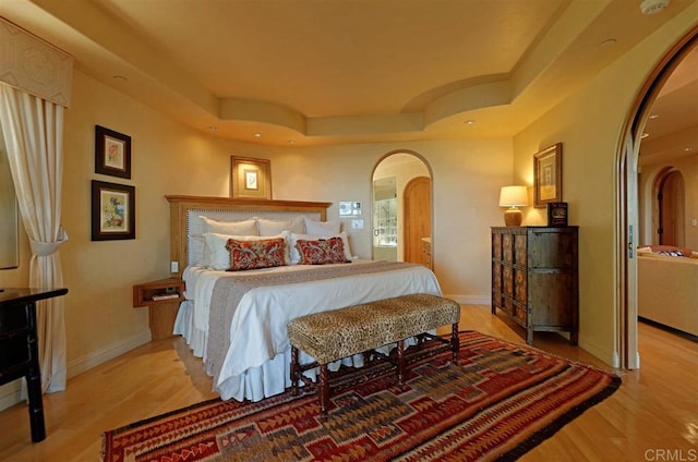 741 Rosecrans, San Diego, CA 92106 - bedroom featuring arched walkways, wood finished floors, a raised ceiling, baseboards, and recessed lighting