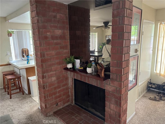 19251 Anaheim Ave Unit 1, Costa Mesa, CA 92627 - detailed view of carpet flooring, a brick fireplace, a ceiling fan, and baseboards