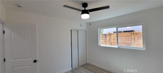 3355 Debbie Ln, Riverside, CA 92501 - unfurnished bedroom featuring a closet, baseboards, light wood finished floors, and a ceiling fan