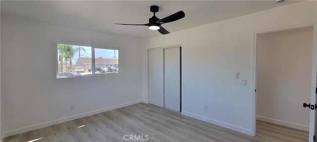 3355 Debbie Ln, Riverside, CA 92501 - unfurnished bedroom featuring light wood finished floors, a closet, baseboards, and ceiling fan