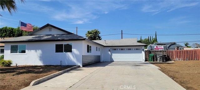 3355 Debbie Ln, Riverside, CA 92501 - view of front facade with a garage, stucco siding, concrete driveway, and roof with shingles