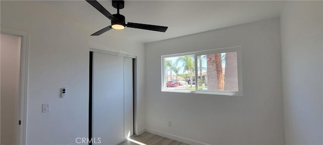 3355 Debbie Ln, Riverside, CA 92501 - unfurnished bedroom with a closet, a ceiling fan, and wood finished floors