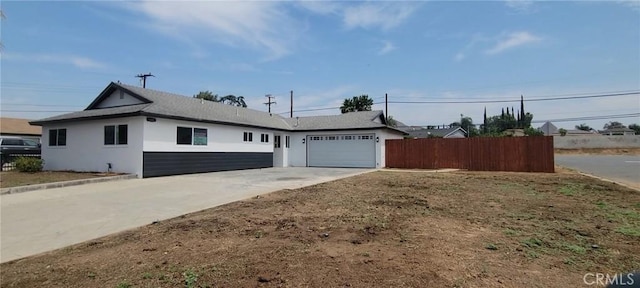 3355 Debbie Ln, Riverside, CA 92501 - ranch-style house featuring driveway, stucco siding, and a garage