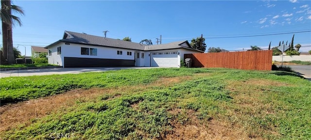 3355 Debbie Ln, Riverside, CA 92501 - view of front of home with a garage, stucco siding, and driveway