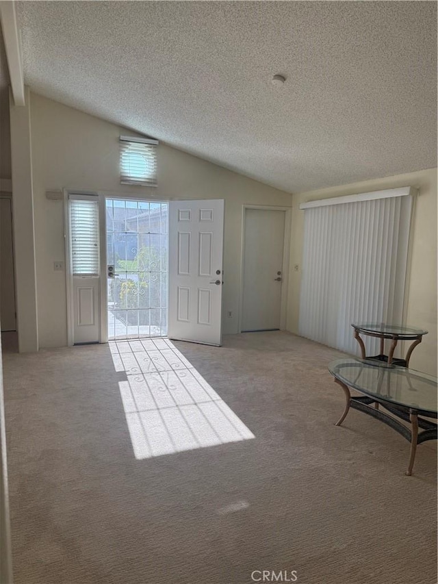 140 W Pioneer Ave Unit 134, Redlands, CA 92374 - foyer featuring lofted ceiling, carpet floors, and a textured ceiling