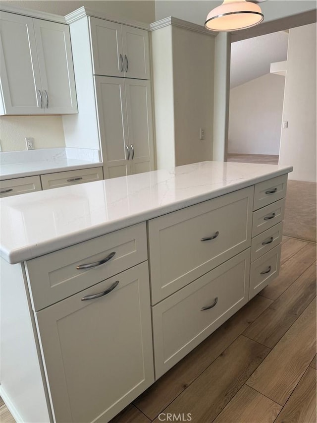 140 W Pioneer Ave Unit 134, Redlands, CA 92374 - kitchen featuring dark wood-style floors, white cabinetry, and light stone counters