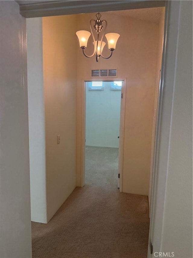 140 W Pioneer Ave Unit 134, Redlands, CA 92374 - corridor featuring carpet floors and a chandelier