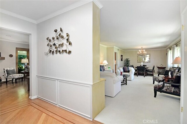 4510 Triste Pl, Tarzana, CA 91356 - living area featuring a chandelier, healthy amount of natural light, crown molding, and wood finished floors
