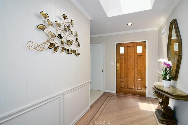 4510 Triste Pl, Tarzana, CA 91356 - entryway with light wood finished floors, a skylight, ornamental molding, recessed lighting, and baseboards