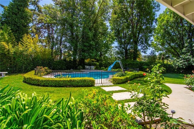 4510 Triste Pl, Tarzana, CA 91356 - view of swimming pool featuring a water slide, a lawn, and a patio